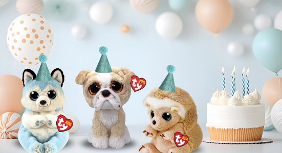 Three beanies with birthday hats and cake and balloons in background