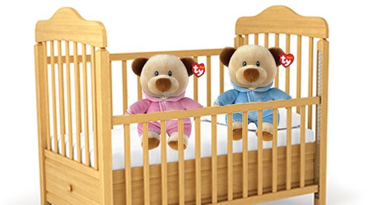 Two Baby Ty Beanie Babies in a crib