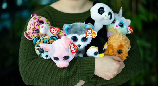 Child hugging a group of Beanie Babies