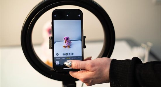 Light circle with phone and beanie in the middle