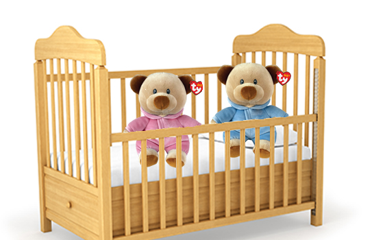 Two Baby Ty Beanie Babies in a crib