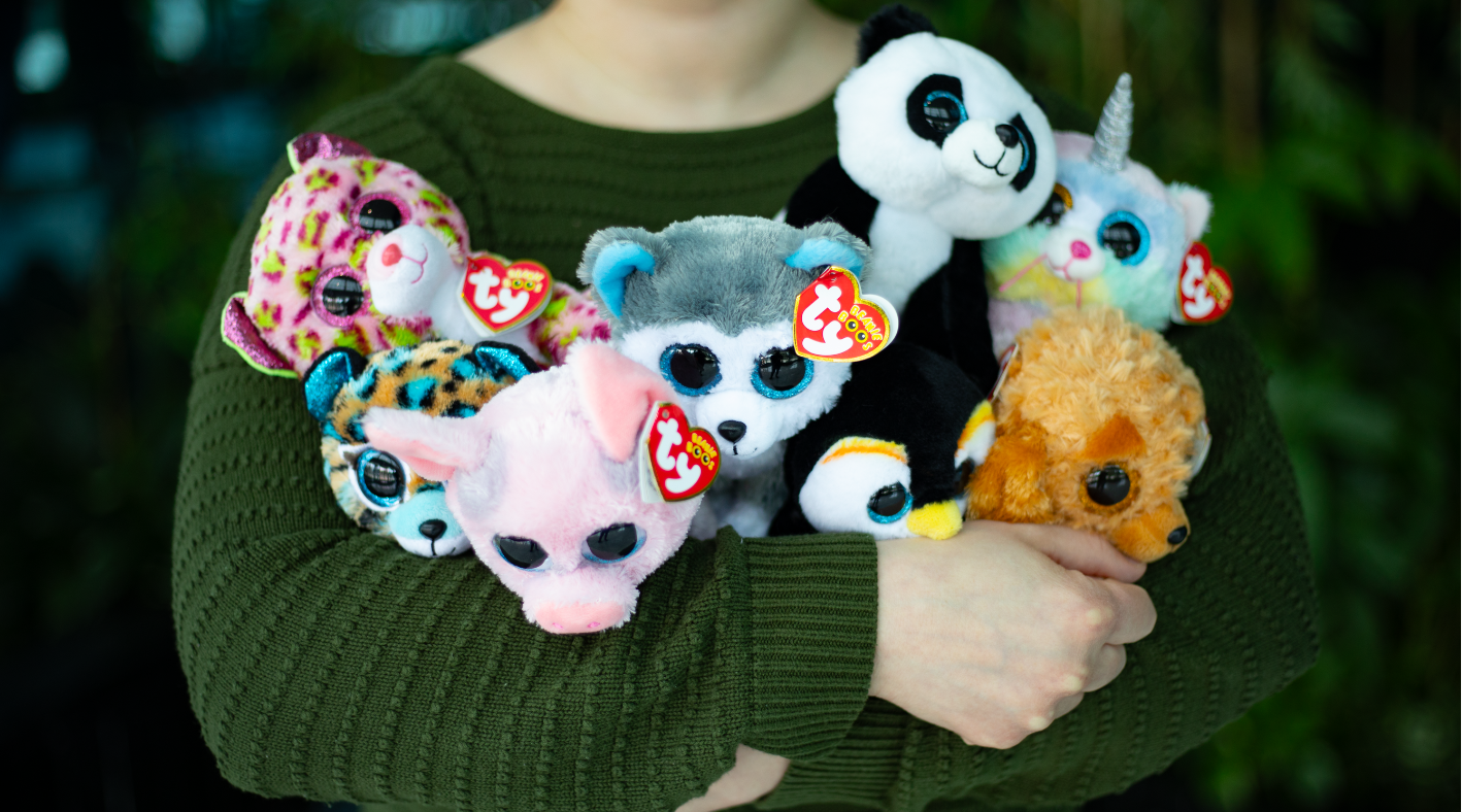Child hugging a group of Beanie Babies