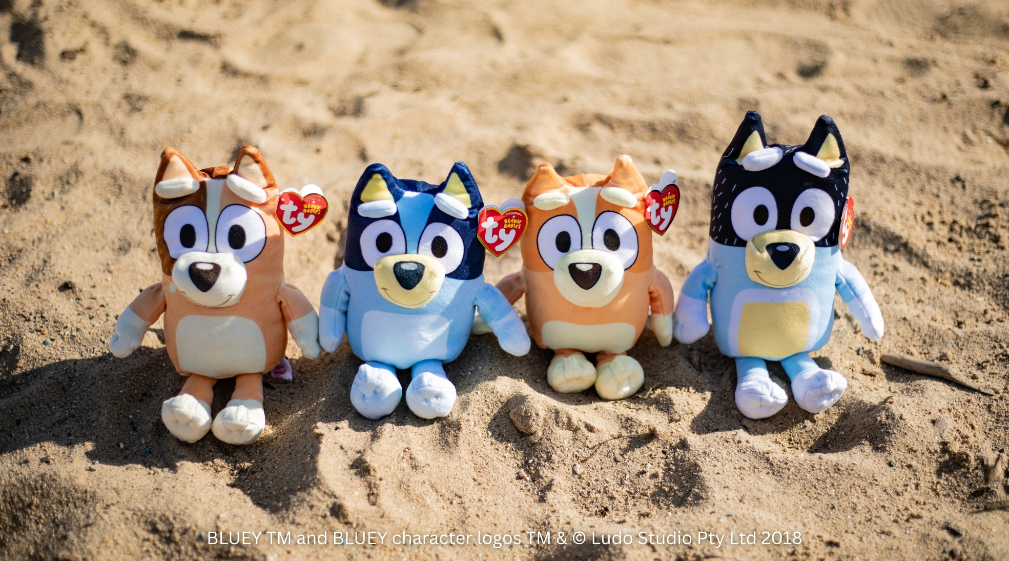 Bluey characters in sand